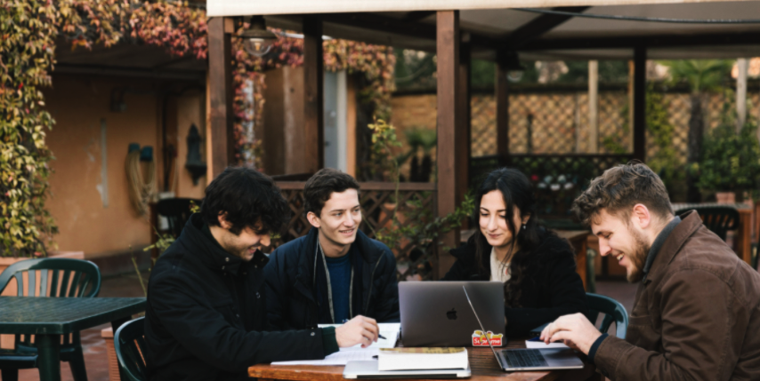 Four students sitting around a table studying